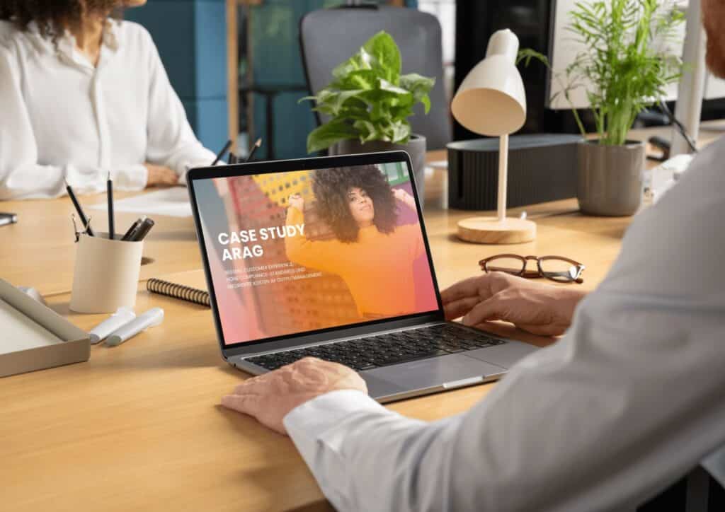 Man with laptop looking at the Case Study ARAG